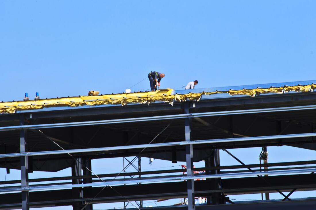 workers on the commercial roofing