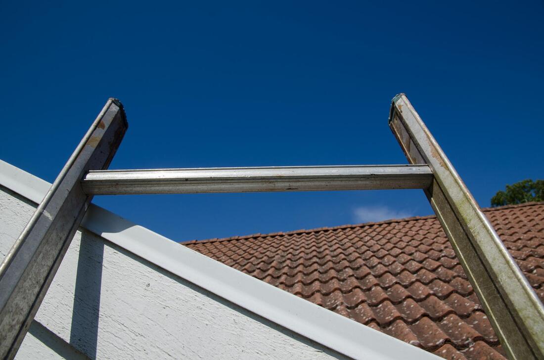 a ladder leaning on the house roof
